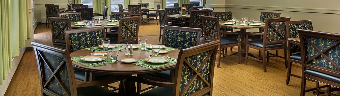 interior of a dinin room with set tables and decor